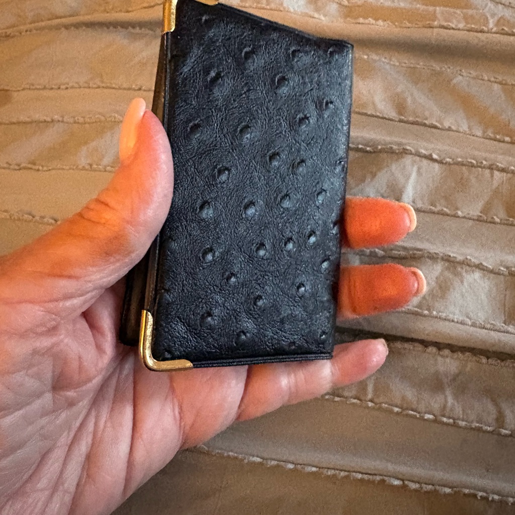 Textured Black Leather Card Holder With Gold Corners Holds Numerous Photos